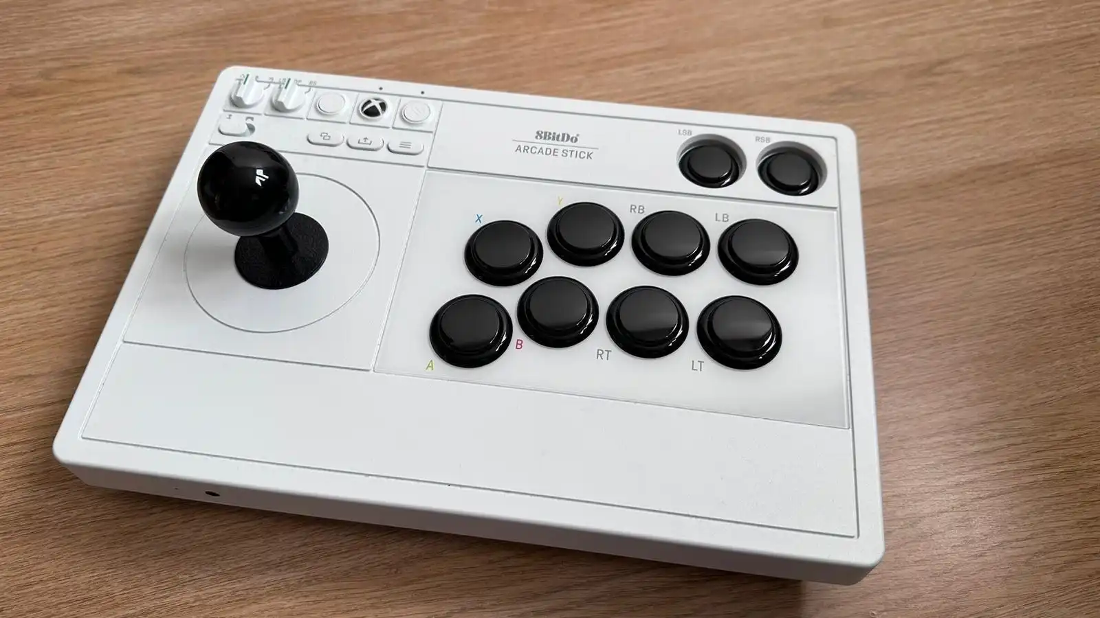 8bitDo arcade stick for Xbox on a table