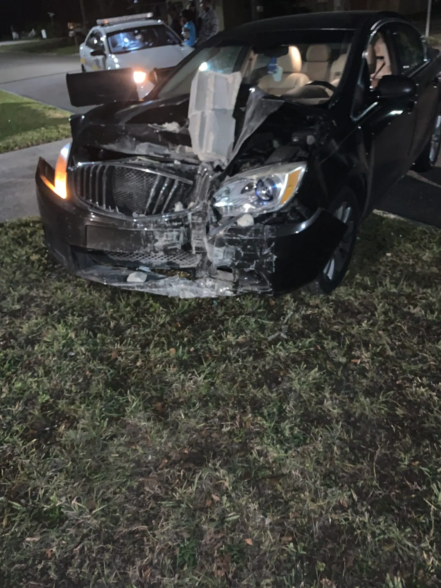 Car with damage to front and police at the scene