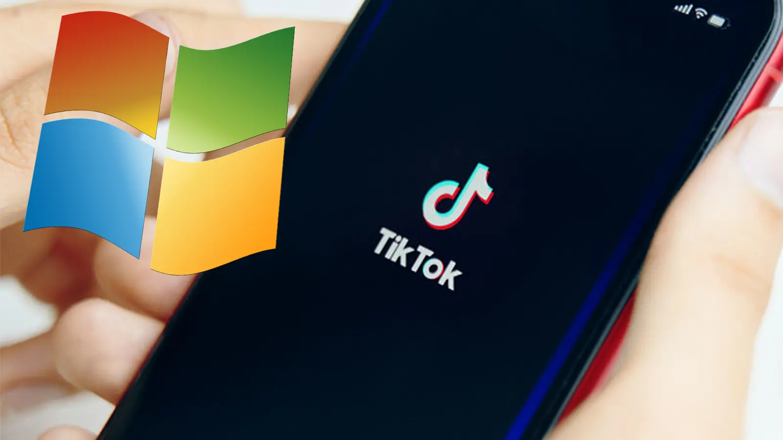 A smartphone with the TikTok logo is held in a person's hand.