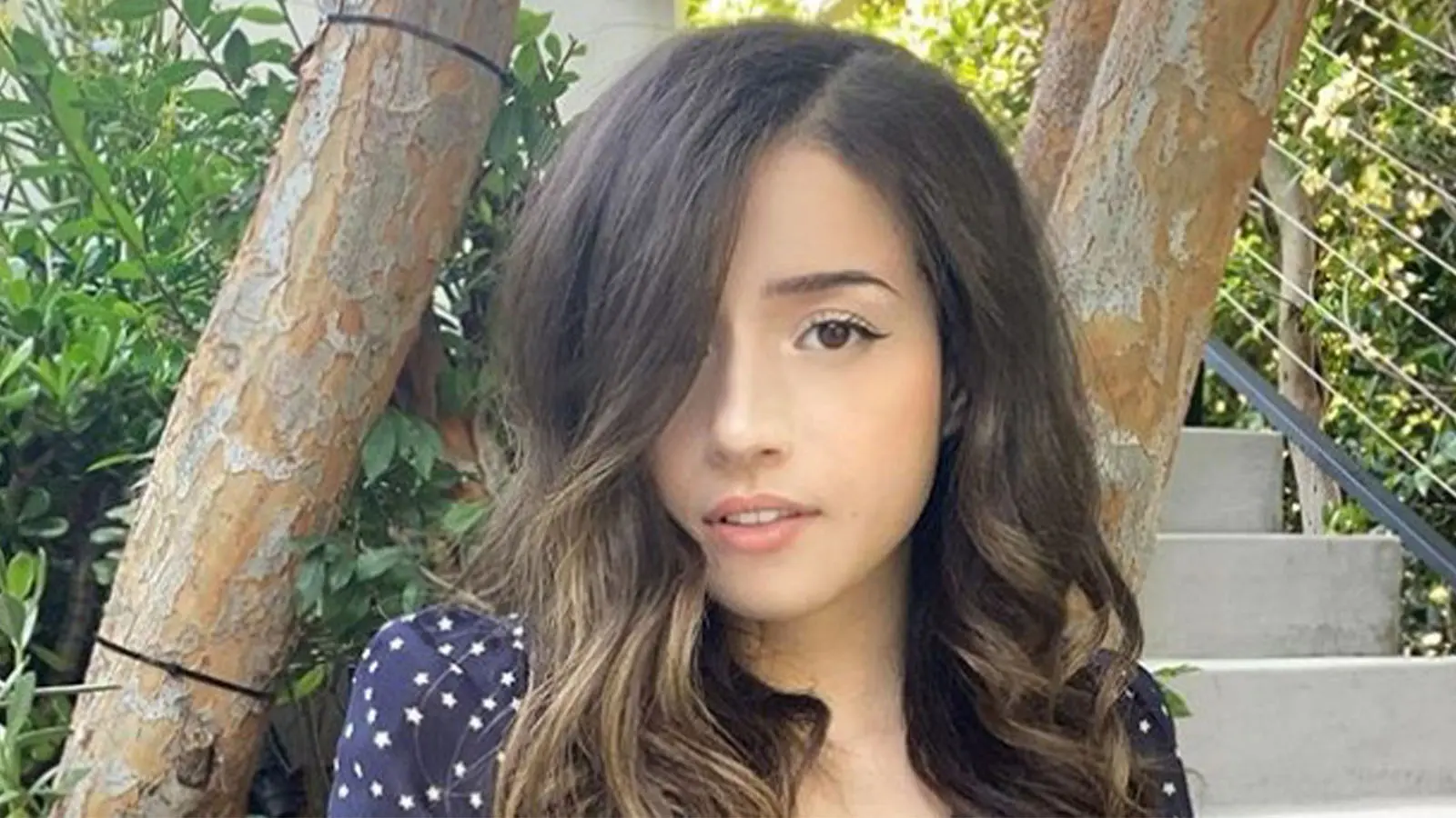 Pokimane taking selfie in greenery