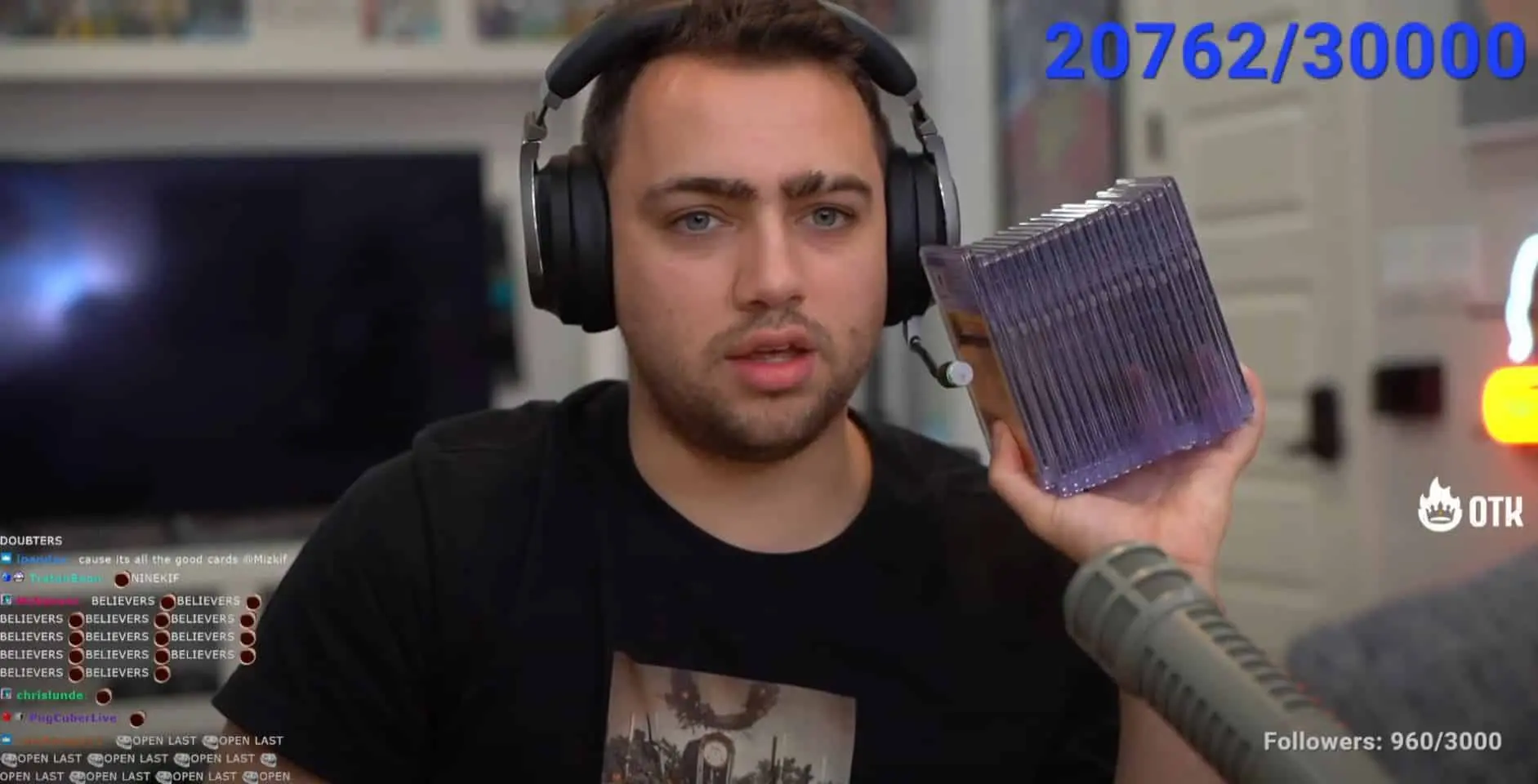 Twitch star Mizkif holding Pokemon Cards