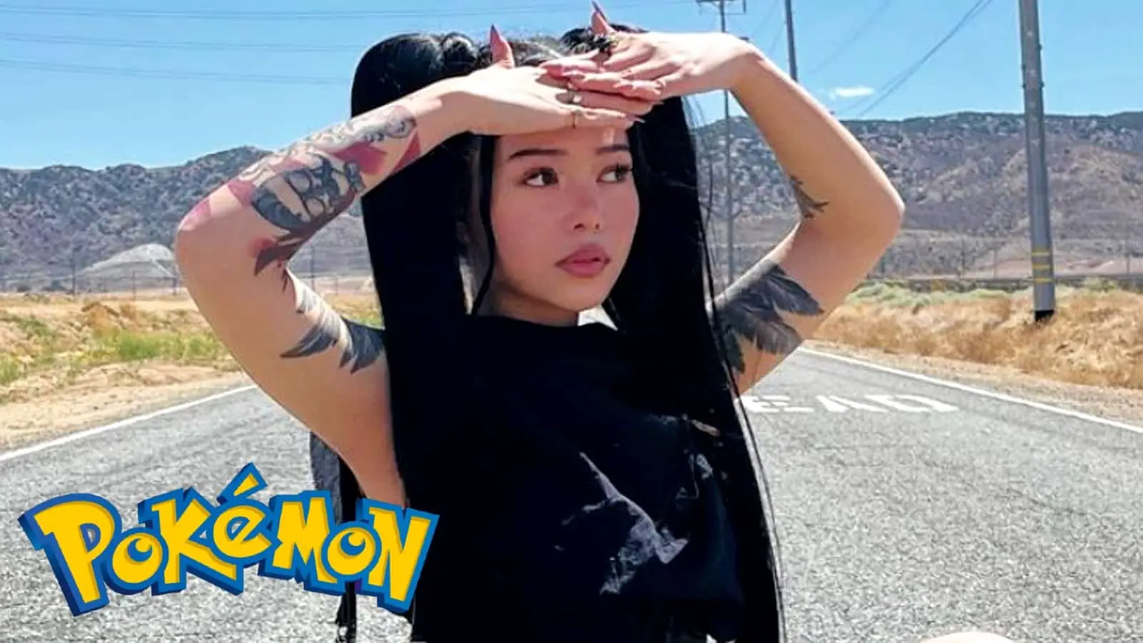 Bella Poarch standing in the road behind a Pokemon logo