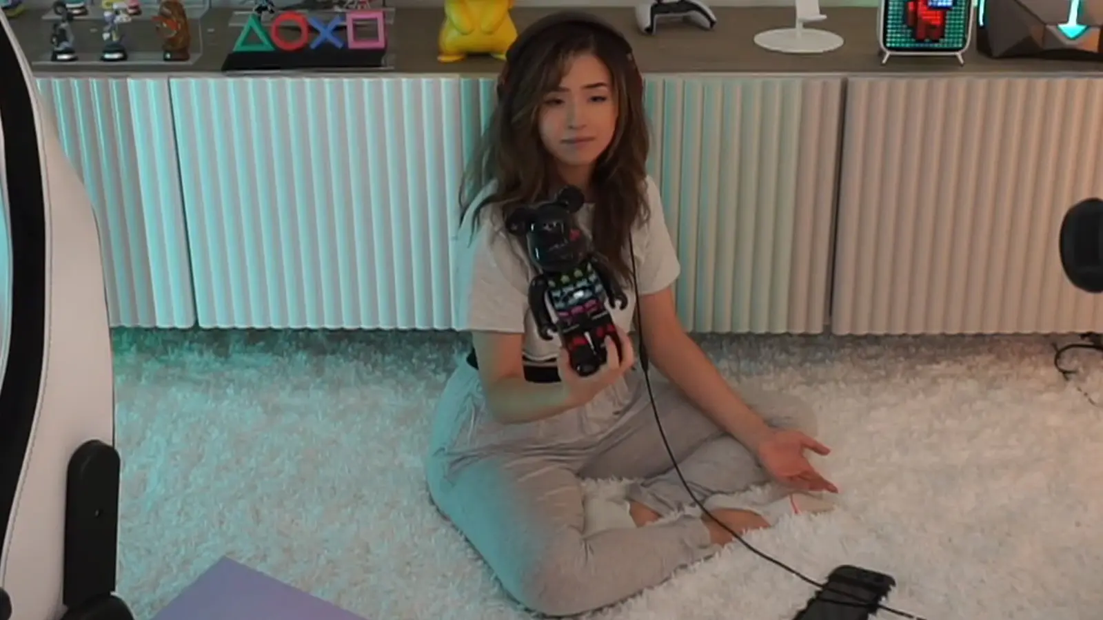 Pokimane holding space invaders bearbrick