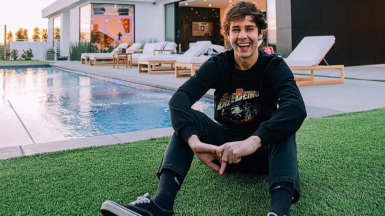 David Dobrik posing outside California home by pool