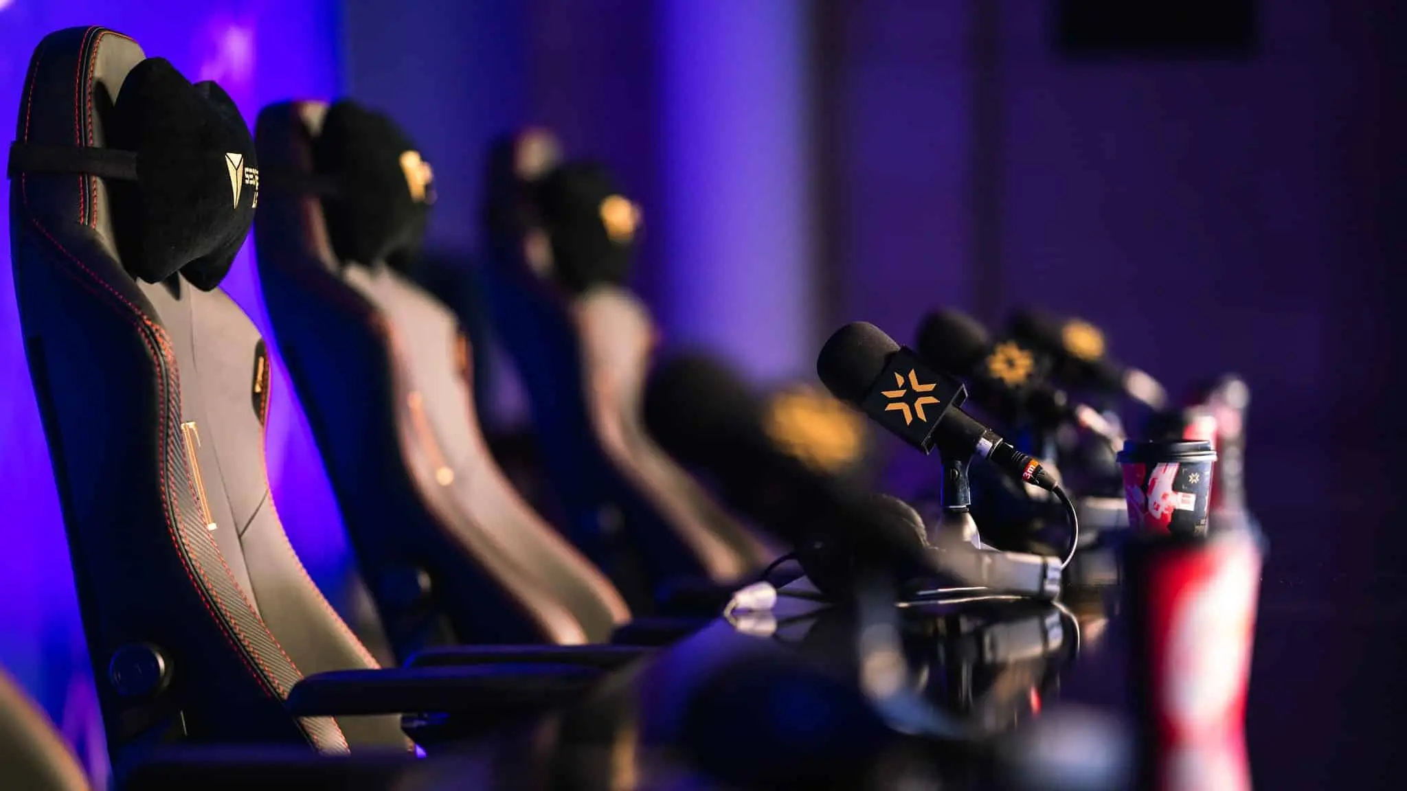 Chairs and microphones at the Valorant Champions press conference lined up without players sitting in them.