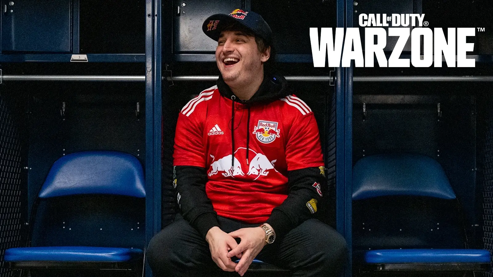 jukeyz wearing red bull jersey in locker room with warzone logo in corner