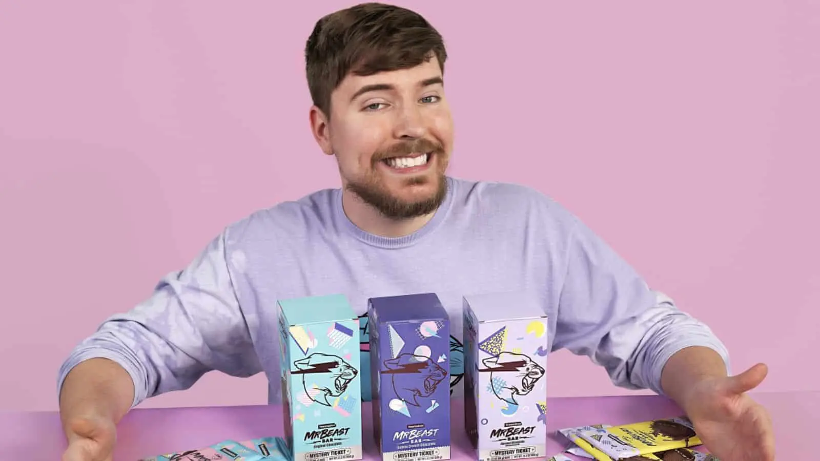 Mr Beast with Feastables chocolates spread out before him