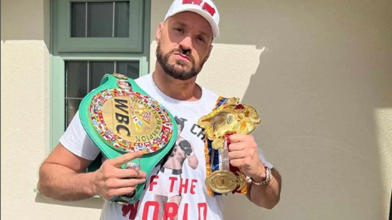 Tyson Fury posing with his wins 