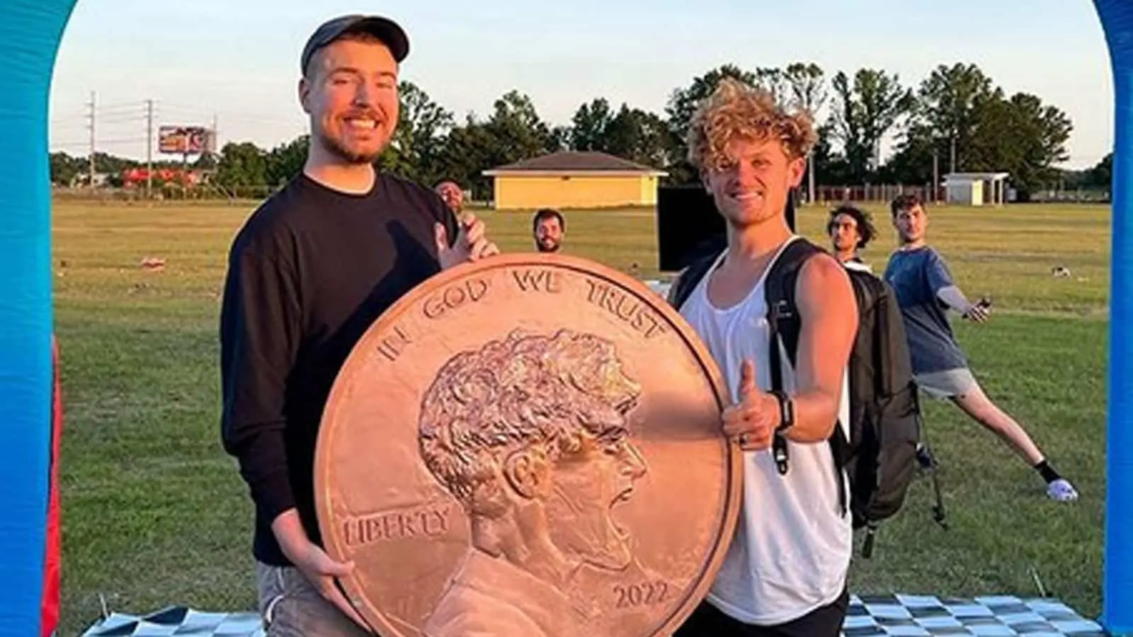 MrBeast and Ryan Trahan holding penny