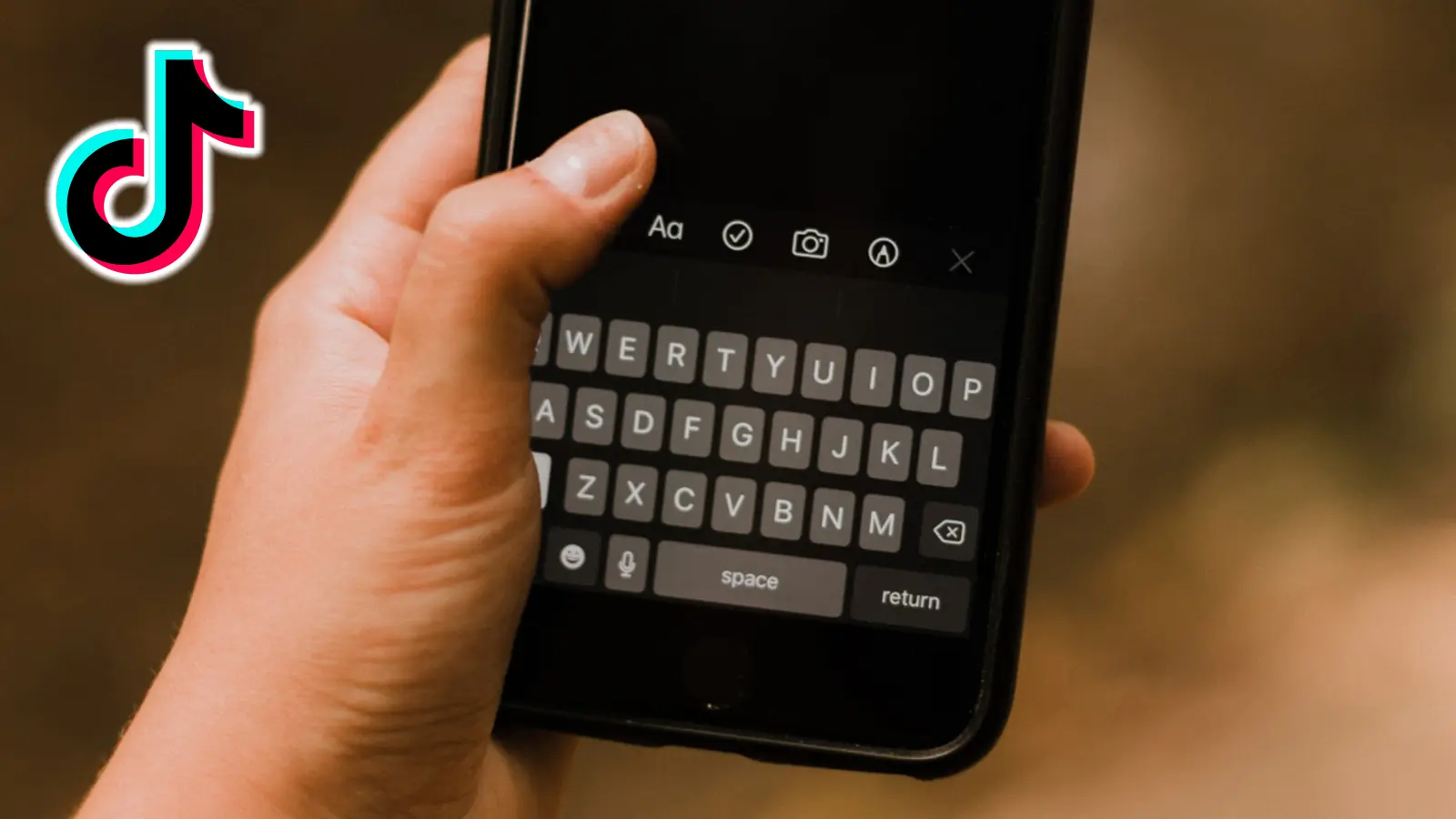 TikTok logo next to phone keyboard