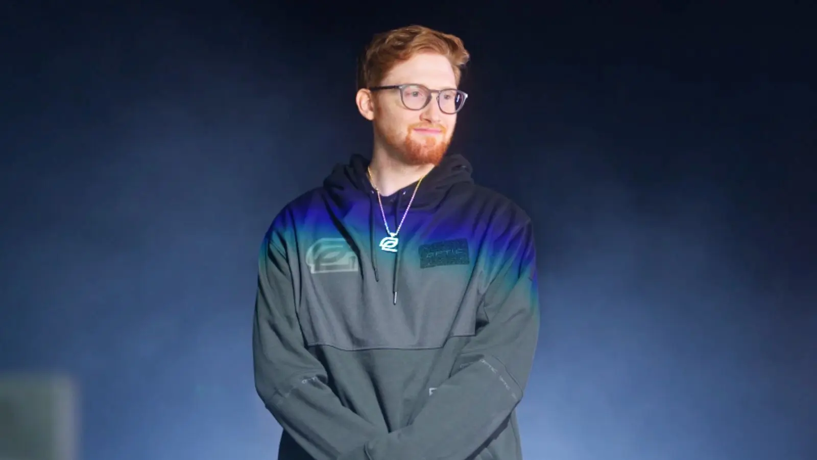 OpTic Scump standing in front of smoky background.