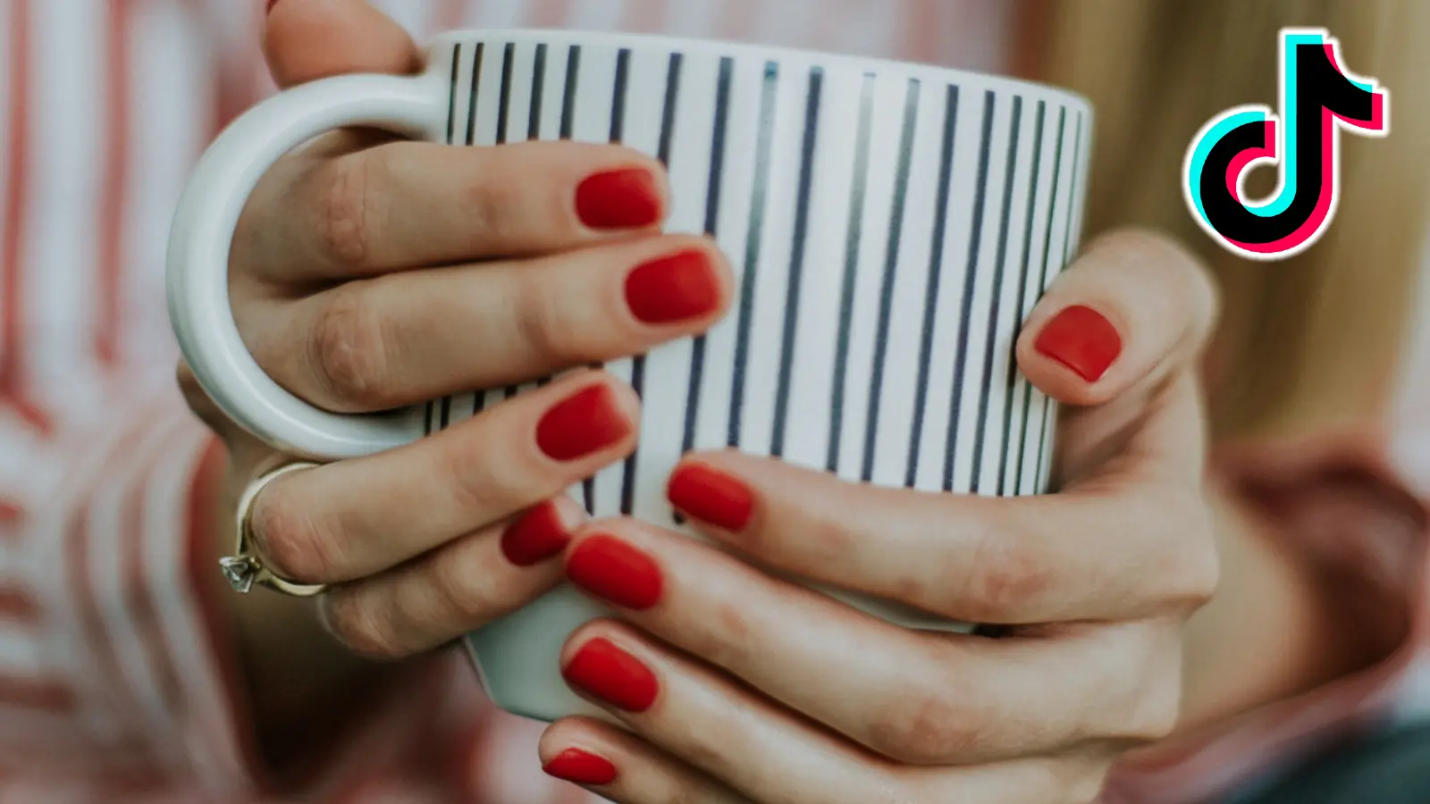 Hands holding a mug