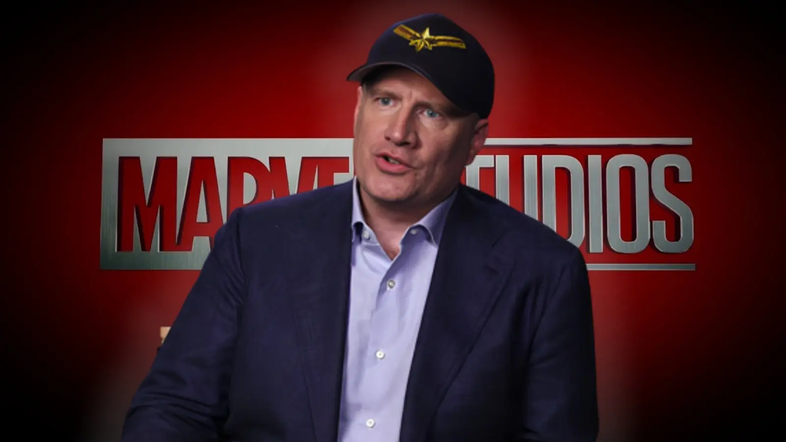 Kevin Feige in front of the MCU Marvel logo