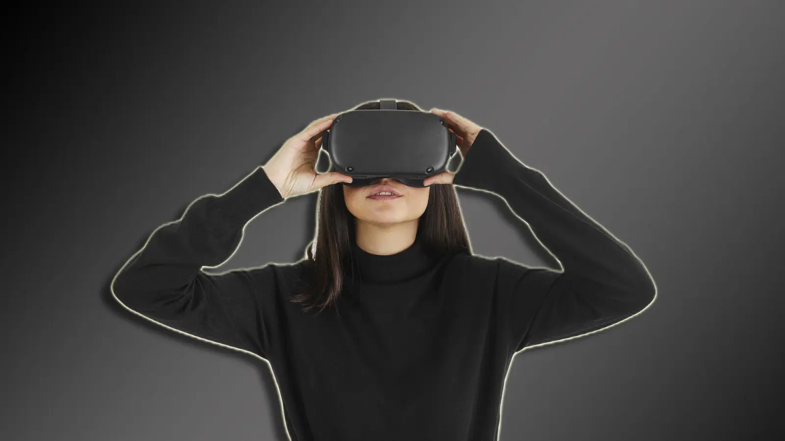 A woman wearing a VR headset on a dark bacground