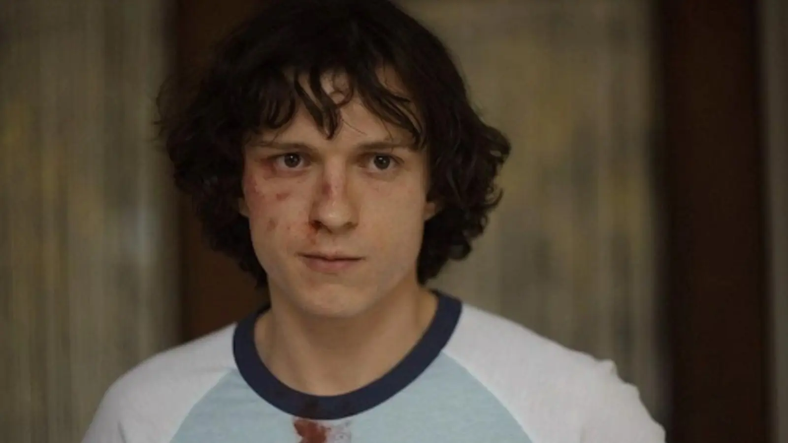 A close up of Tom Holland with a busted eye in The Crowded Room