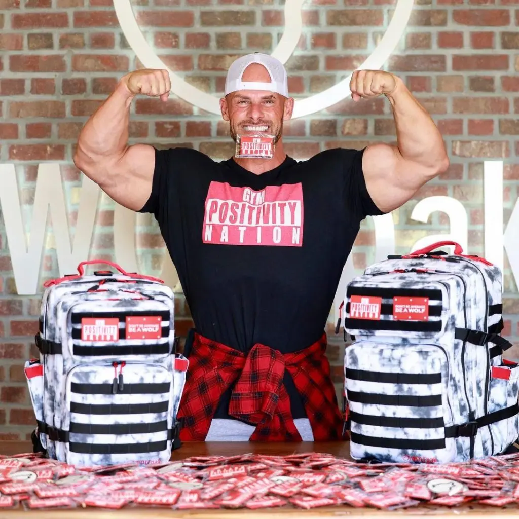 Joey Swoll flexes while promoting his merchandise.