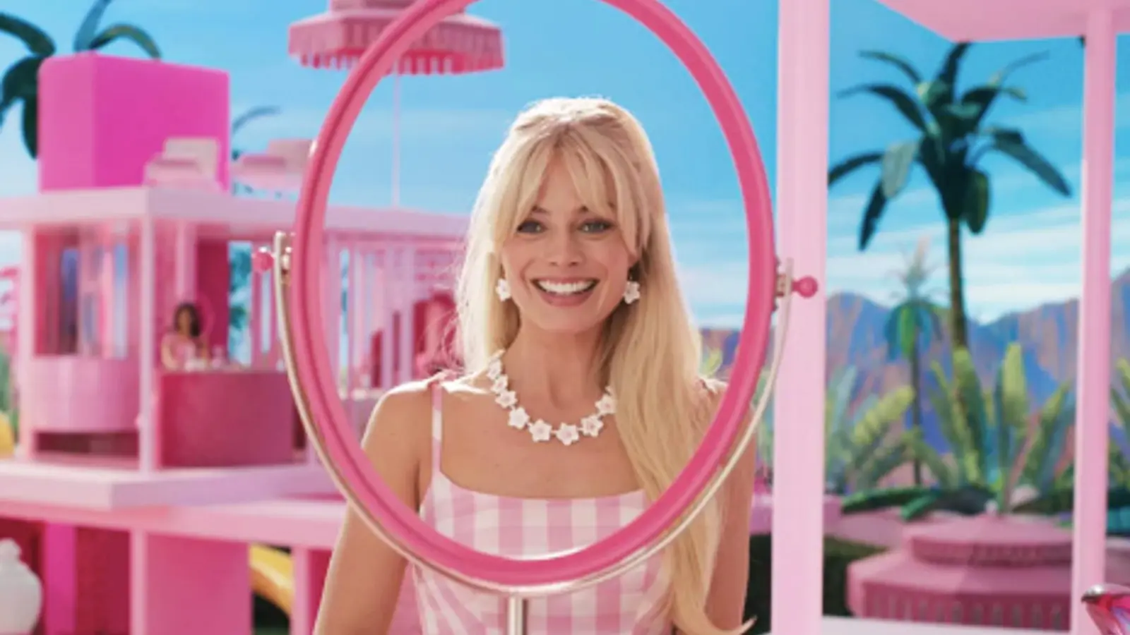 Margot Robbie as Barbie looks into a mirror