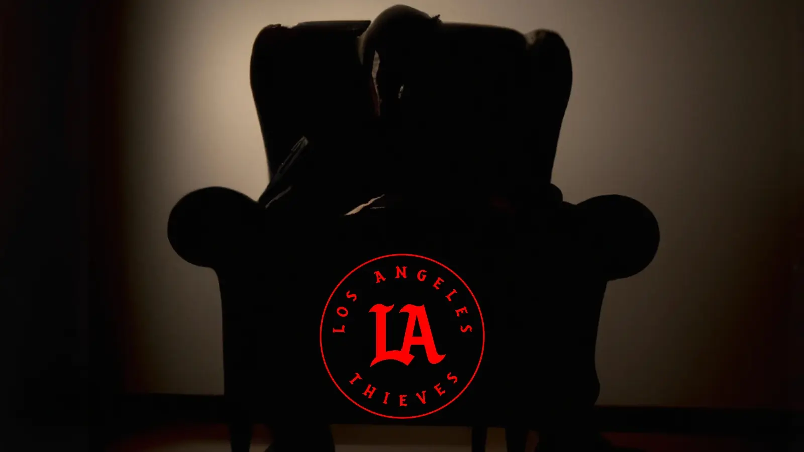 silhouetted man in armchair with LA Thieves logo