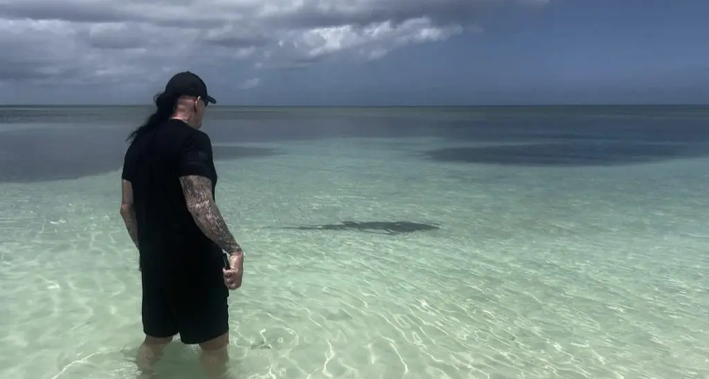 Undertaker protects his wife Michelle McCool from rare shark encounter.