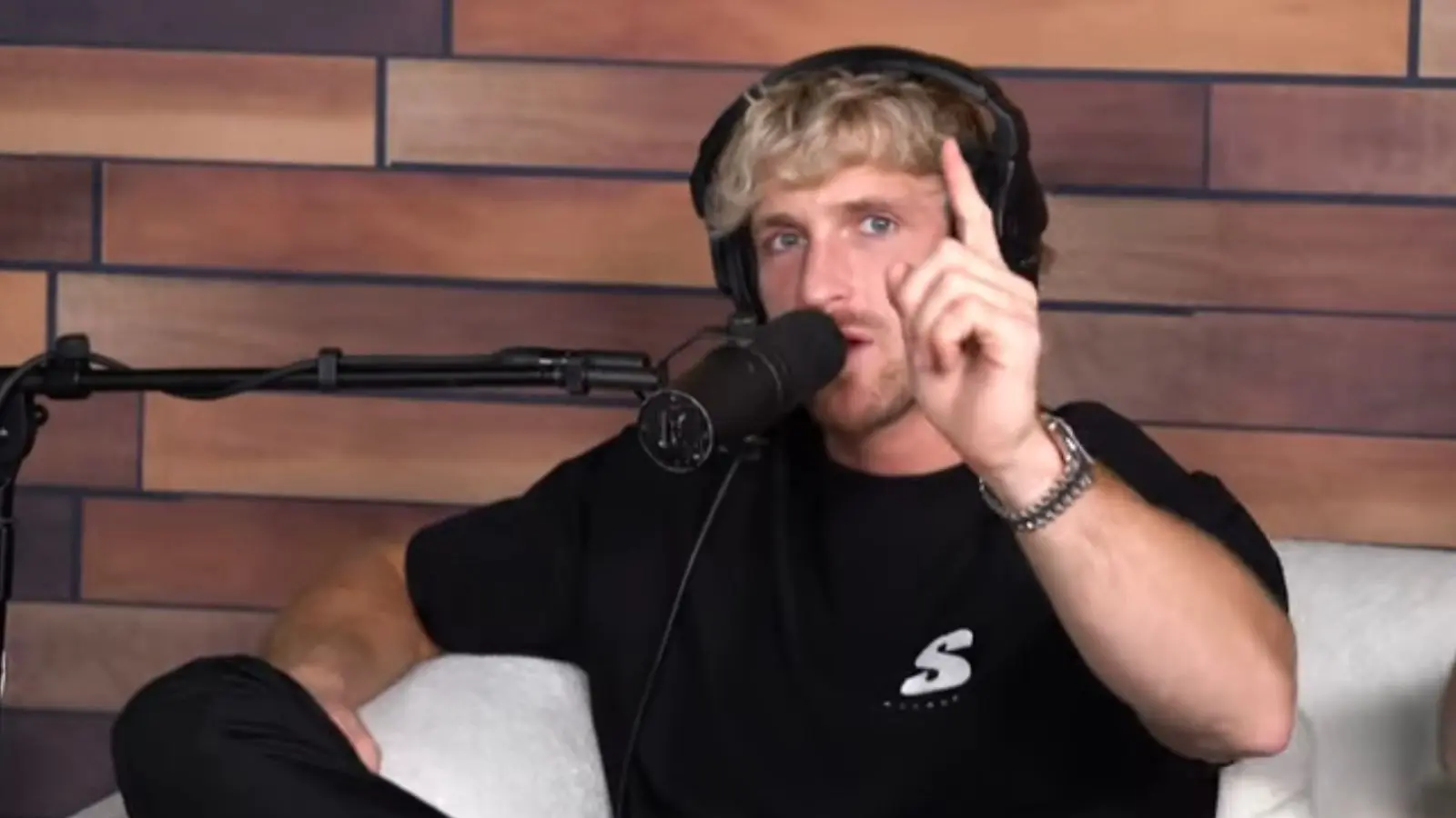 Logan Paul on his Impaulsive podcast in a black tshirt