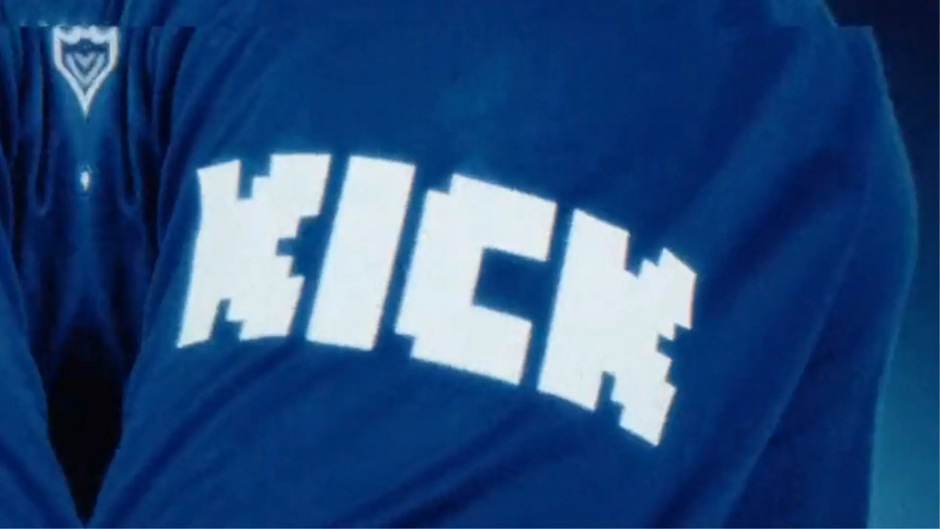 Kick logo on blue shirt pointed at camera