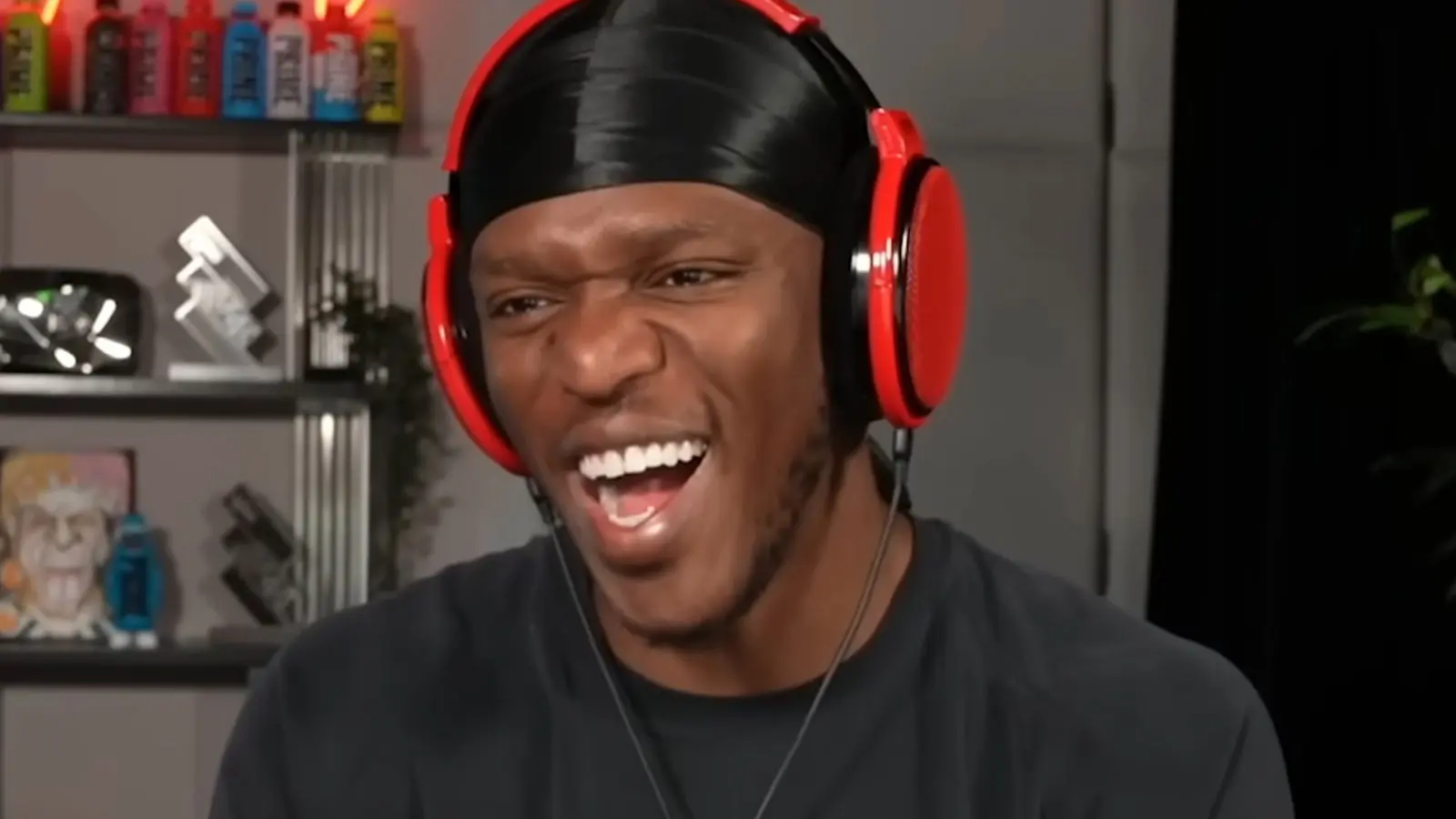 KSI laughing at his desk