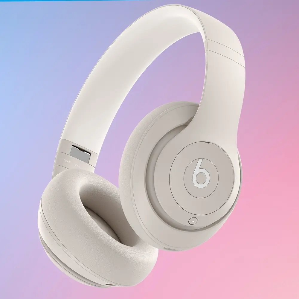 Beats Studio Pro headphones on colorful gradient background