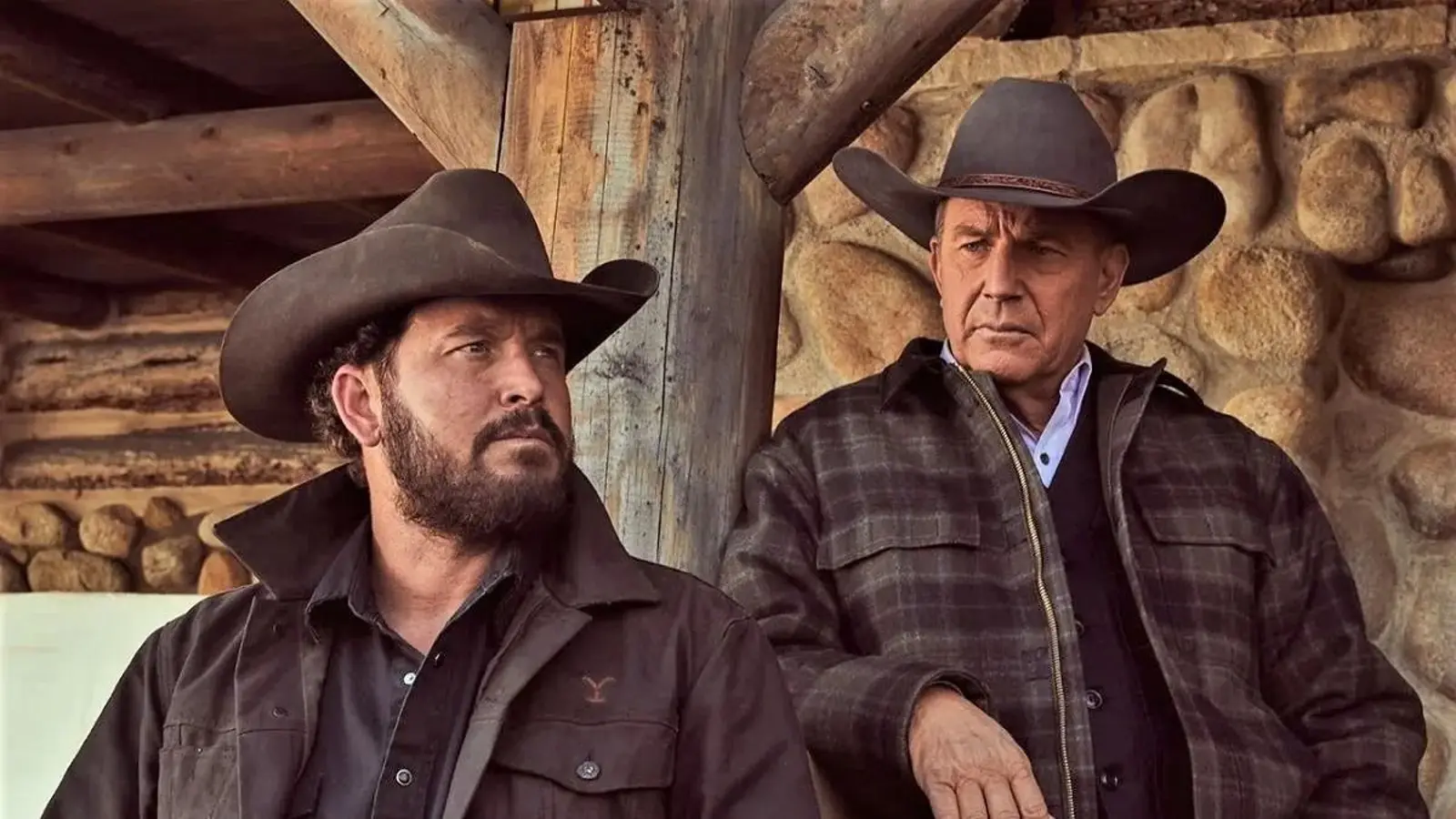 Kevin Costner leans against a post in Yellowstone.