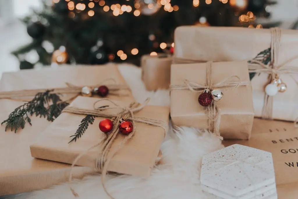 Presents are placed underneath a Christmas tree.