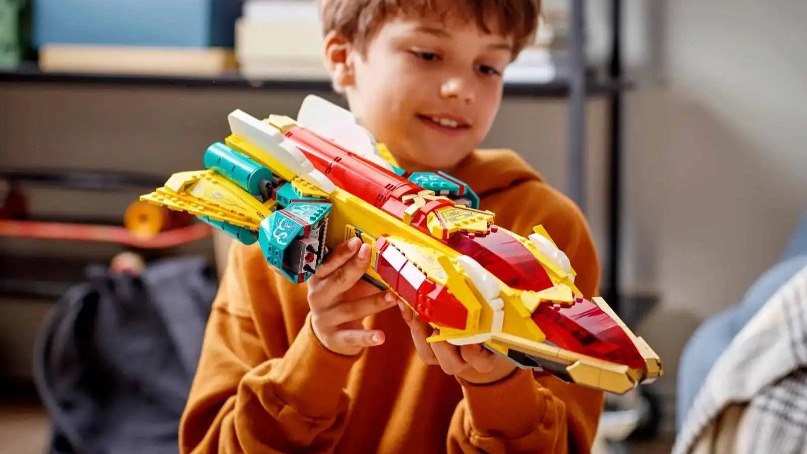 A child playing with their LEGO Monkie Kid's Galactic Explorer set.