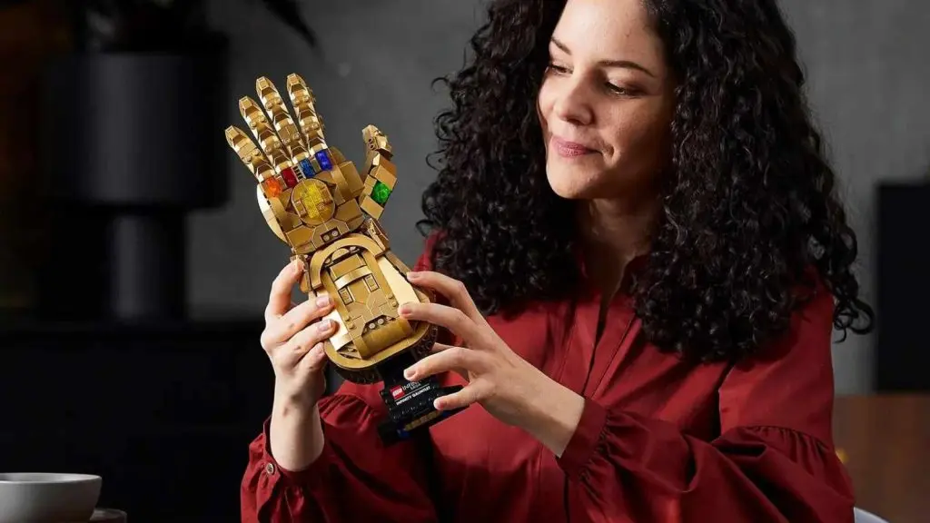 An adult admiring their LEGO Marvel Infinity Gauntlet