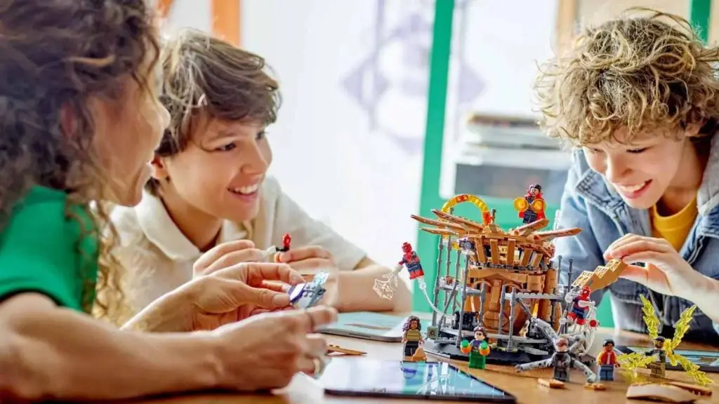 Three children playing with the LEGO Marvel Spider-Man Final Battle set