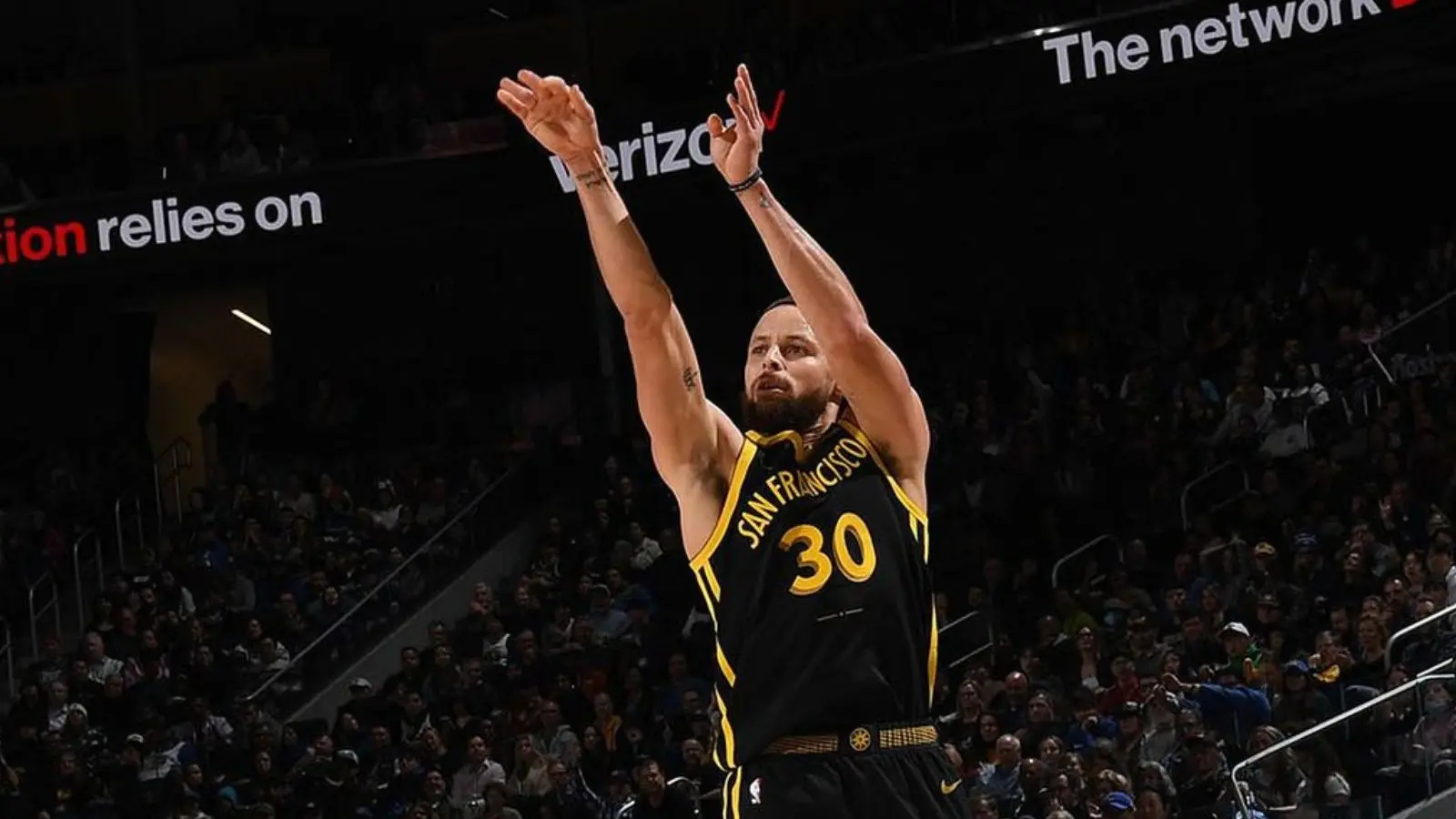 Steph Curry attempting a jump-shot in a game.