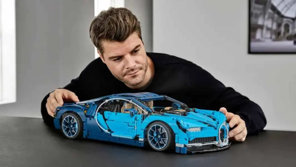 An adult with their LEGO-reimagined Bugatti Chiron