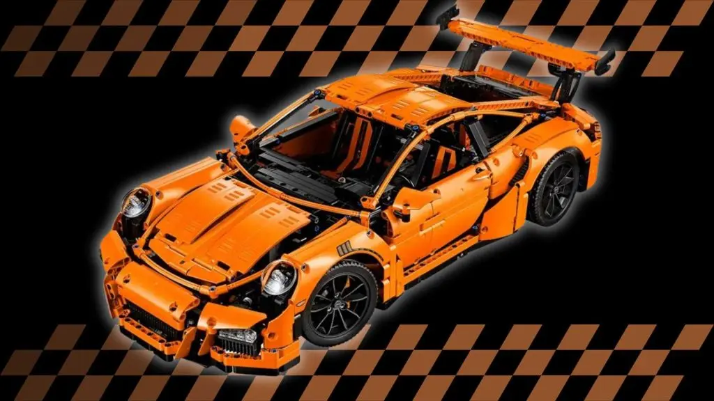 The LEGO Technic Porsche 911 GT3 RS on a black background with orange racing stripes