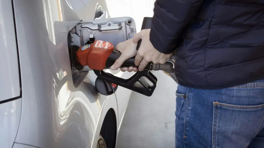 guy pumping gas into car