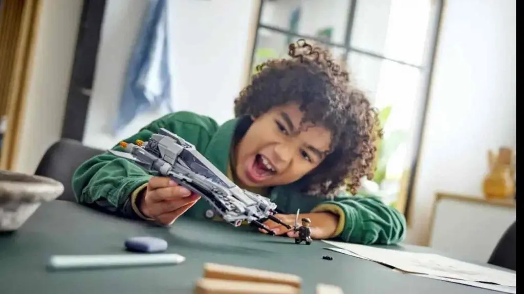 A child playing with their LEGO Star Wars Pirate Snub Fighter