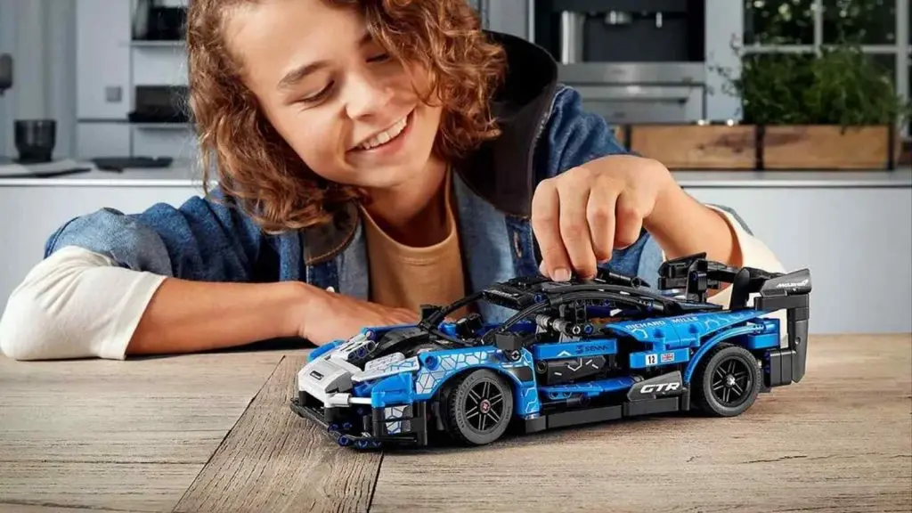 A child playing with their LEGO Technic McLaren Senna GTR