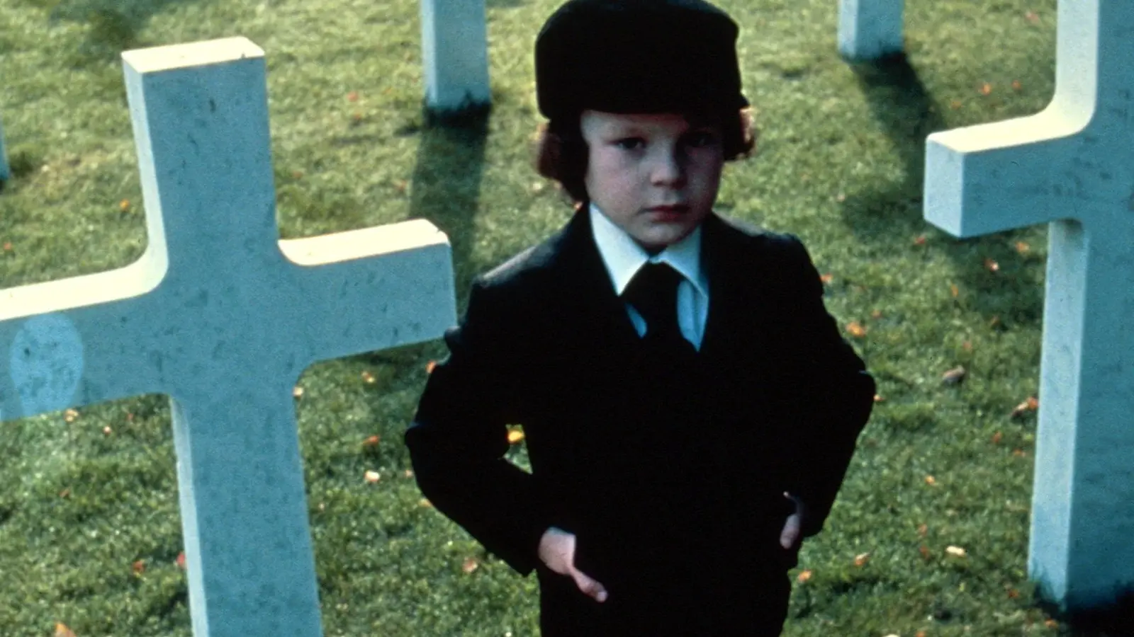 Damien in a graveyard in The Omen.