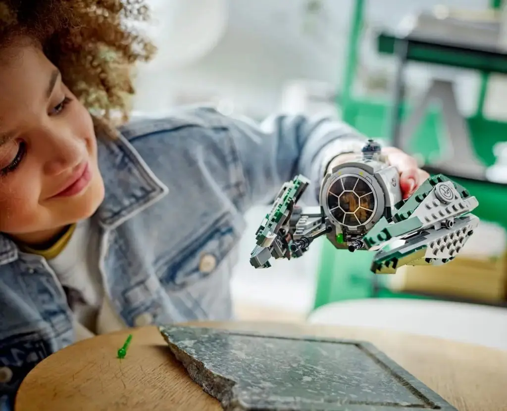 A child playing with their LEGO Star Wars Yoda's Jedi Starfighter