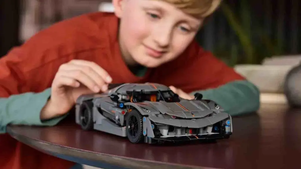 A child with their LEGO Technic Koenigsegg Jesko Absolut Grey Hypercar