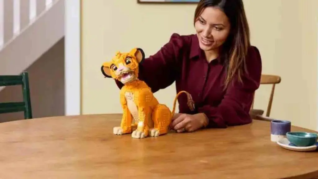 An adult with their LEGO Simba