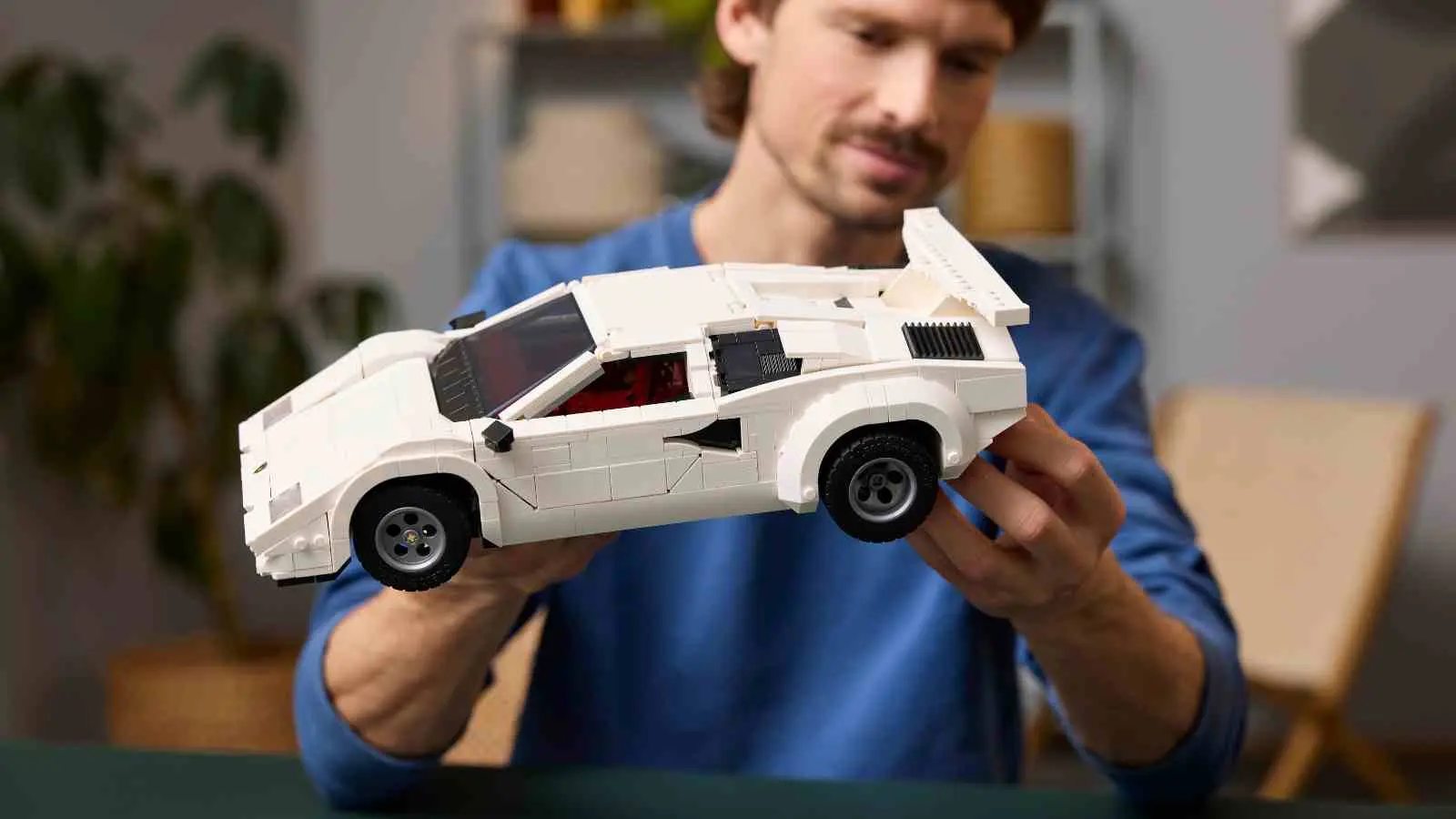 An adult with their LEGO Lamborghini Countach