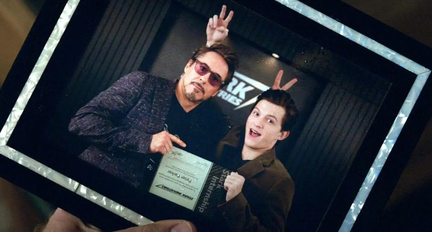 Robert Downey Jr. and Tom Holland as Tony Stark and Peter Parker, posing in a picture together