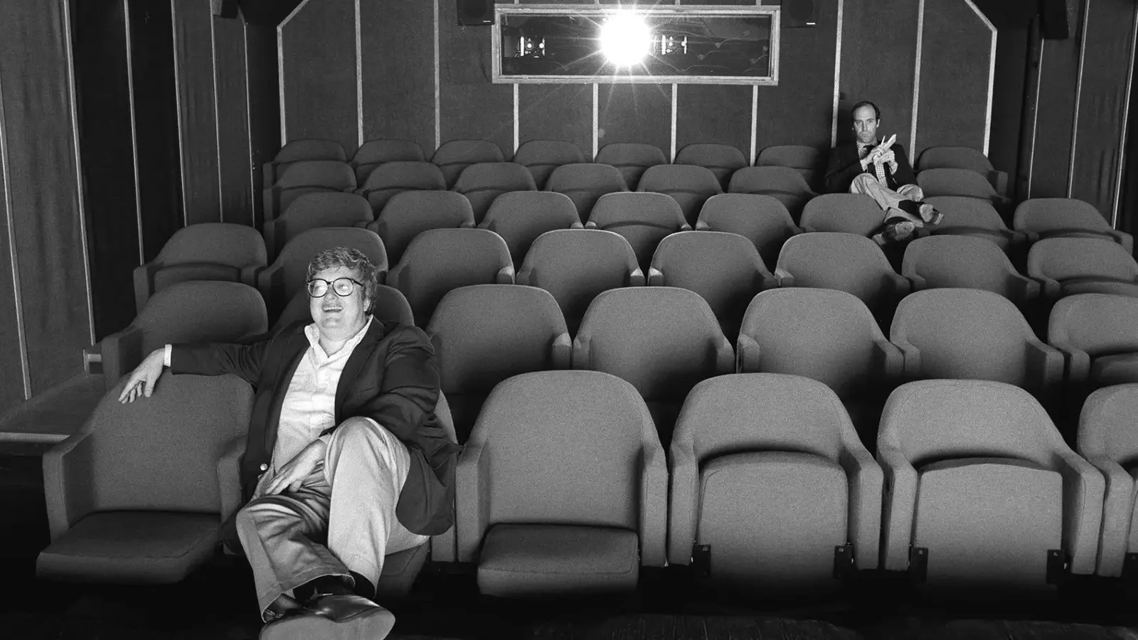 Roger Ebert and Gene Siskel sitting in a cinema.