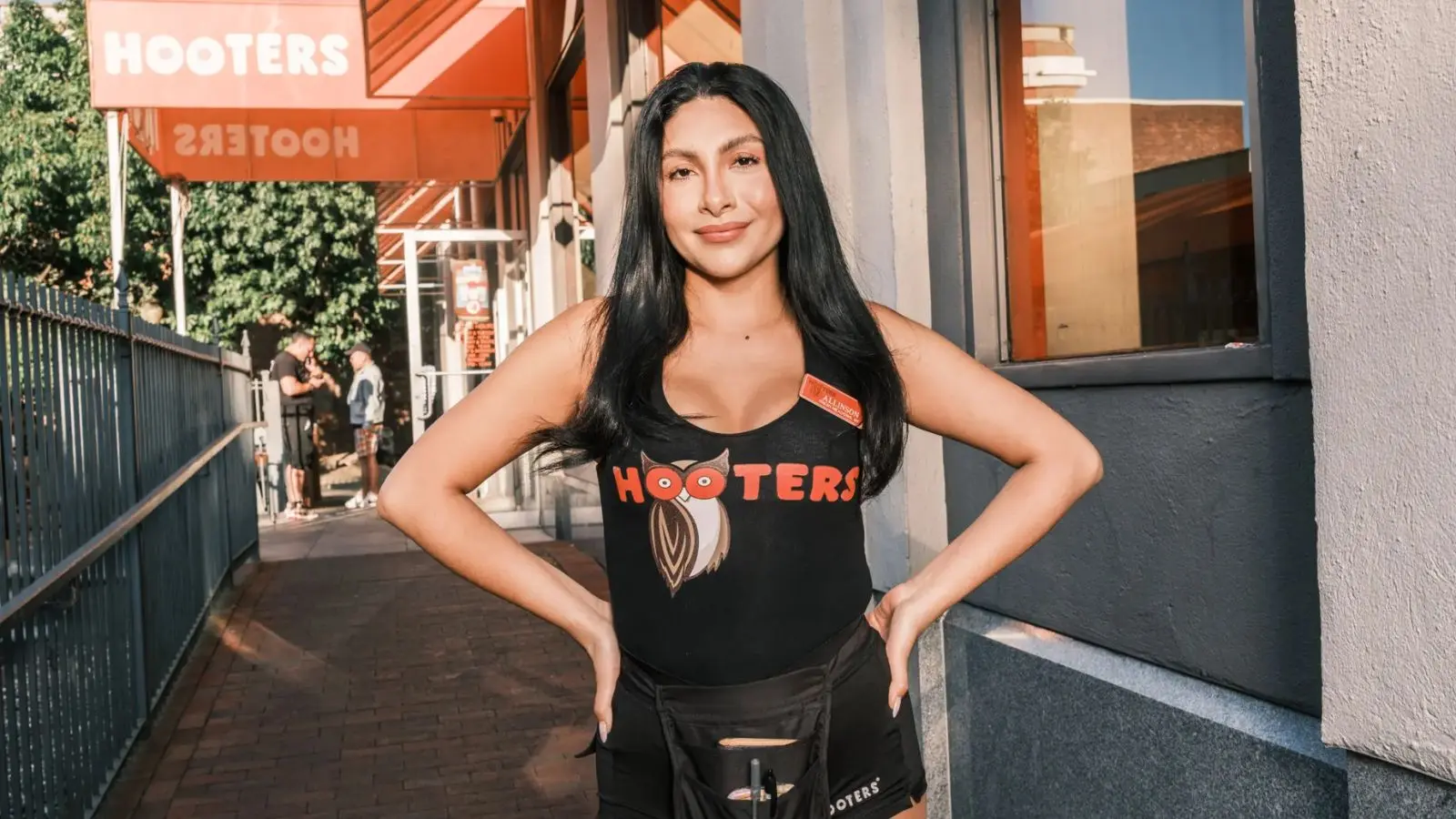 Chalvez, standing outside a Hooters restaurant.