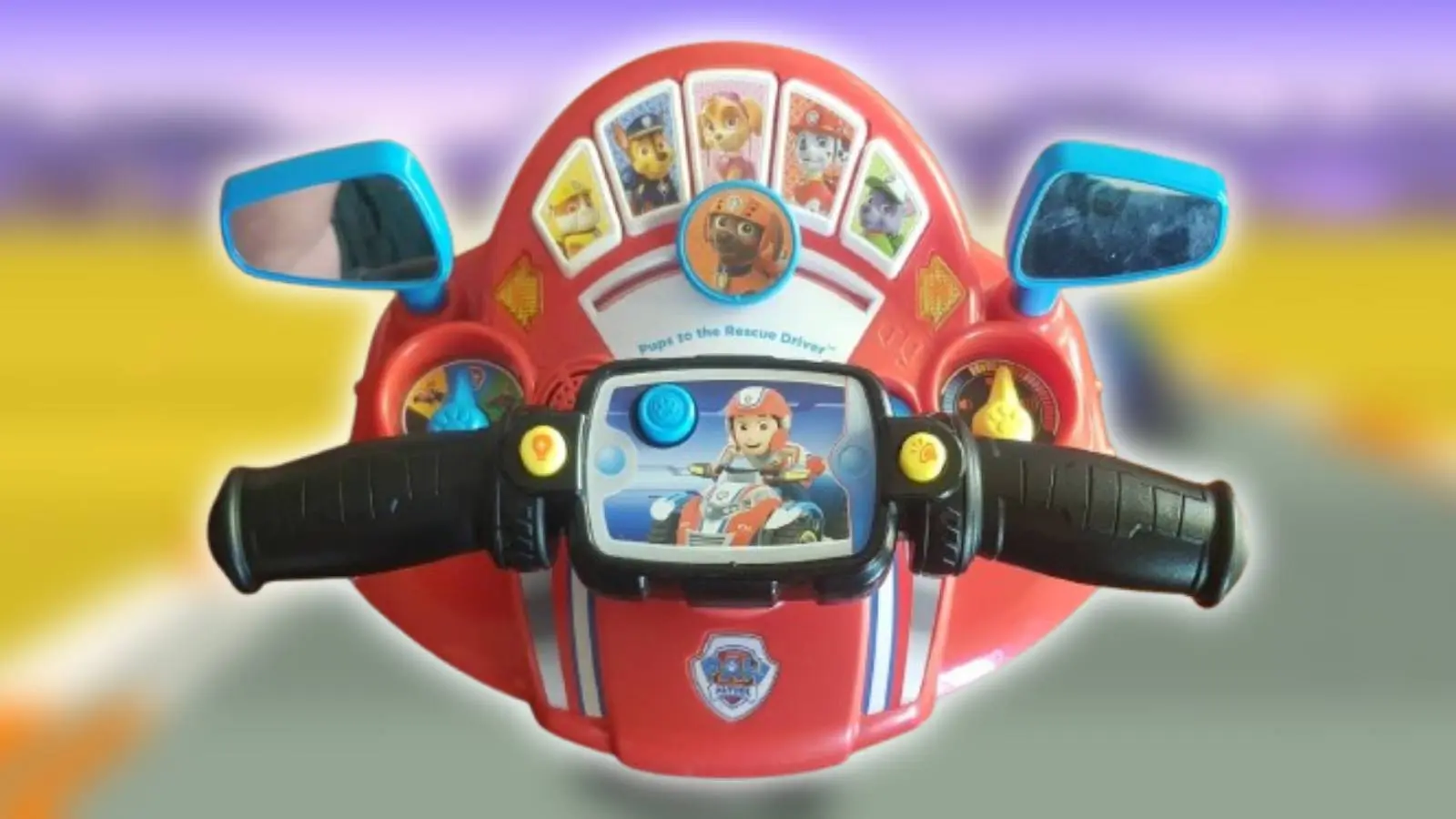 Photo of Thomas Tilley's Paw Patrol controller with a screenshot from Super Hang-On in the background.