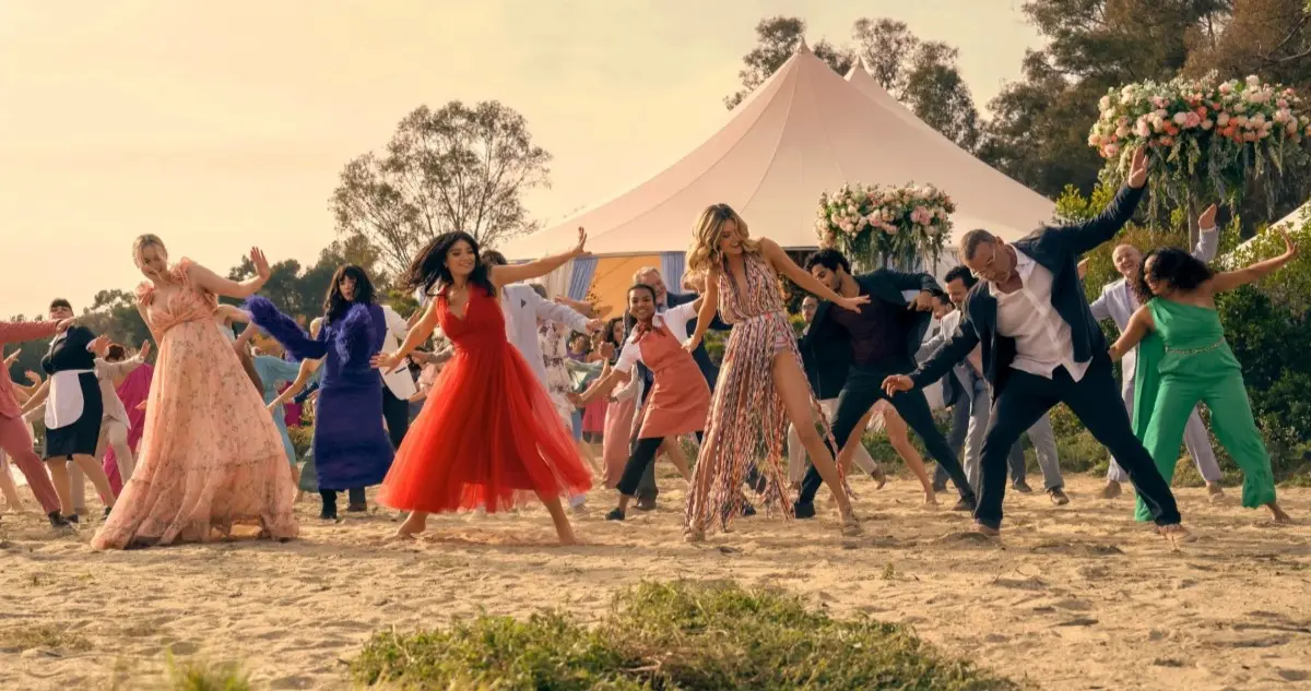 The cast of The Perfect Couple dance on the beach