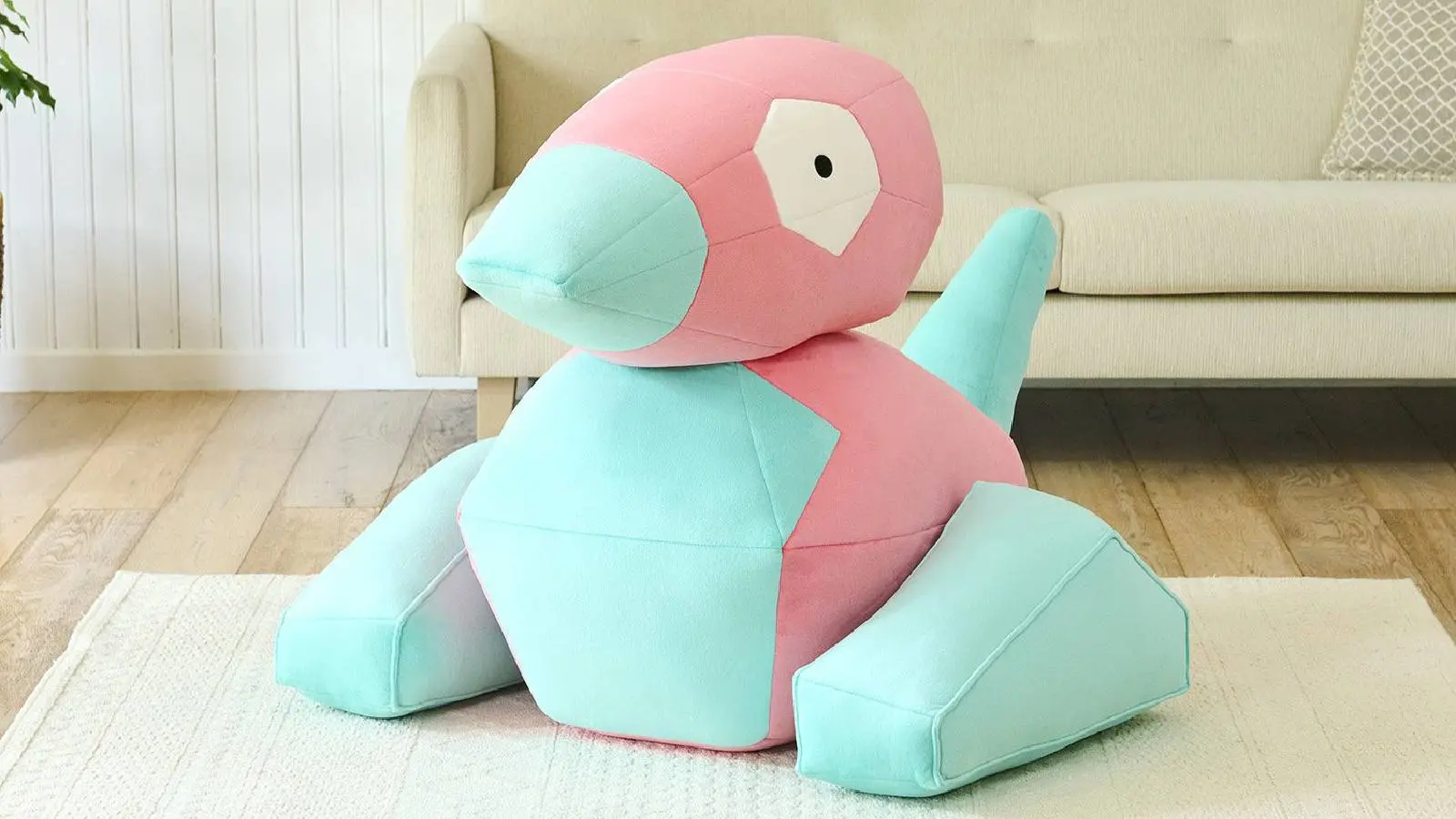 A large Porygon plush is shown on a carpet