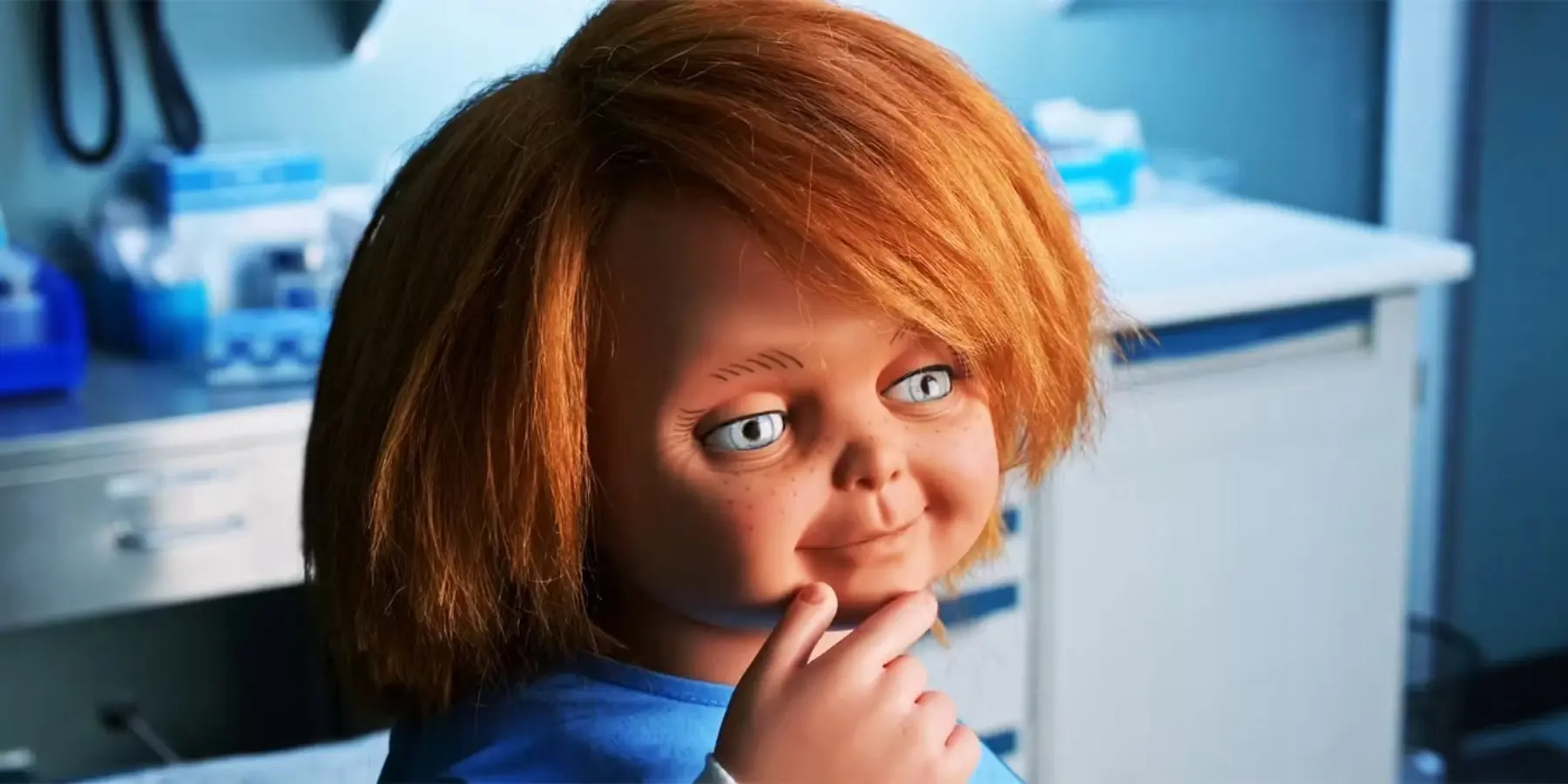 Chucky the doll holding a hand to his face in the tv show